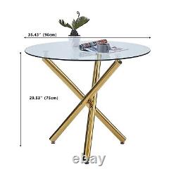 4 chaises de salle à manger blanches en faux cuir et table à manger ronde en verre transparent avec pieds dorés.